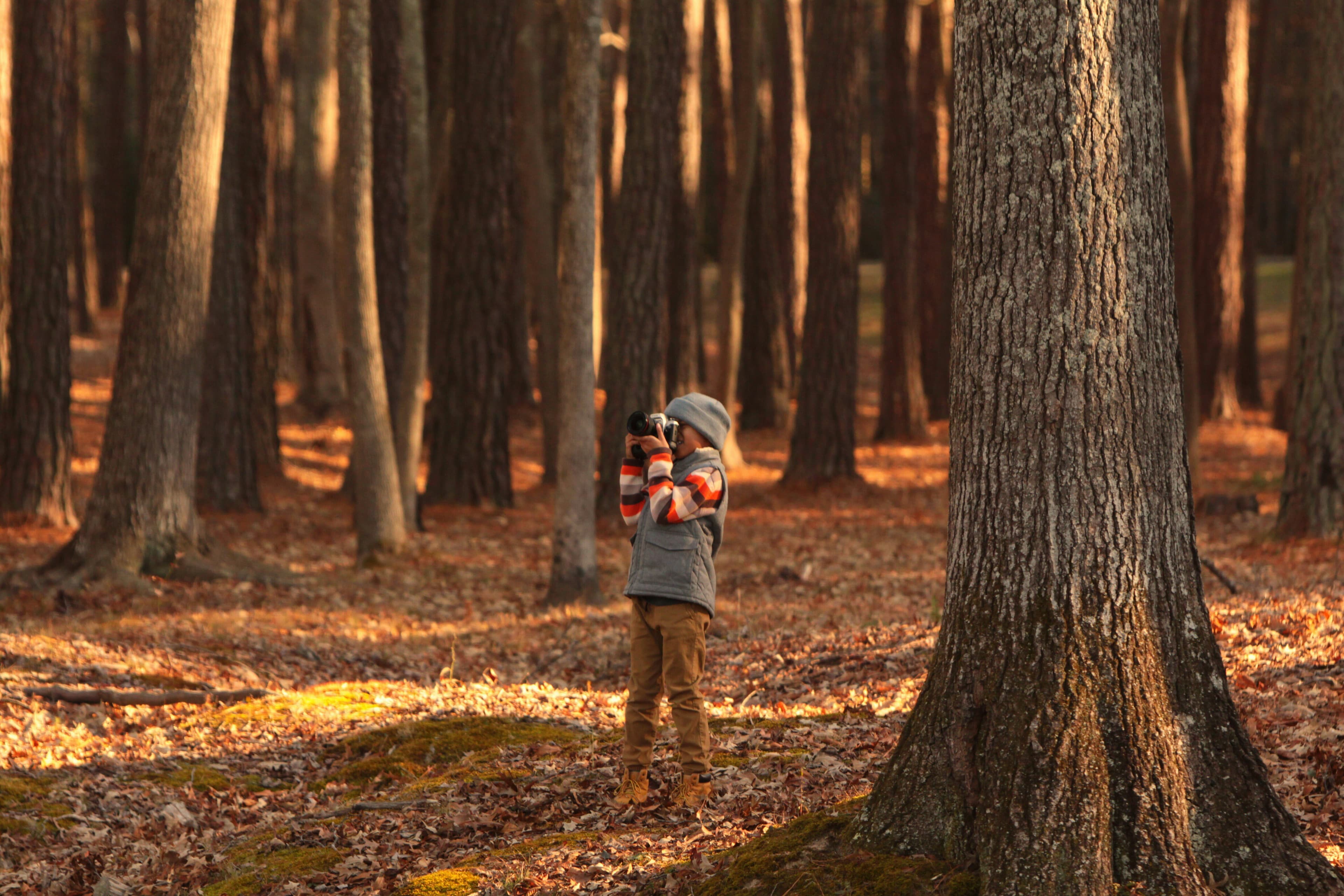 Boy camera in forest
